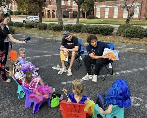 Students reading to school children